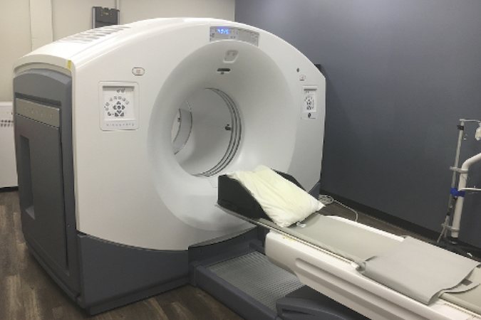 CT system includes a circular scanning gantry housing the x-ray tube and detector which are opposite to one another, a moving table on which the patient is placed, an x-ray generator, and a computerized data processing unit.