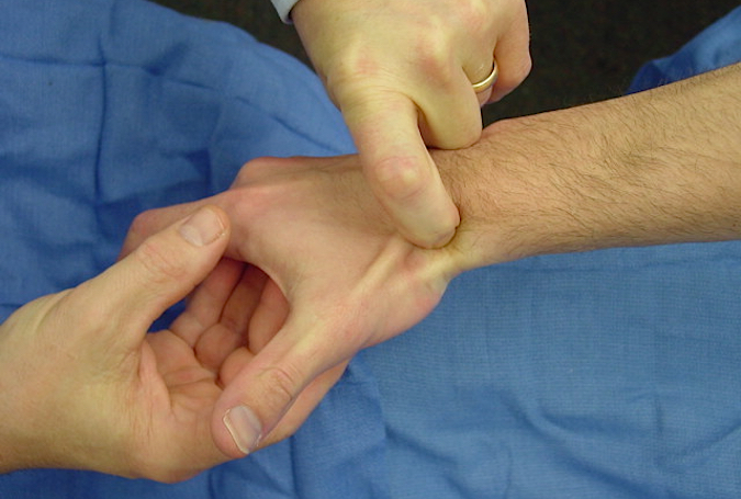 Palpation of scaphoid in anatomic snuff box.